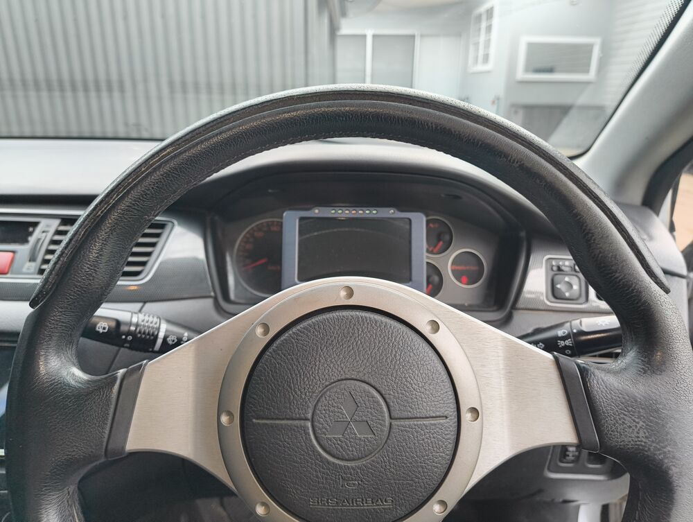 OEM Momo steering wheel with Plex SDM300 display visible in the cluster