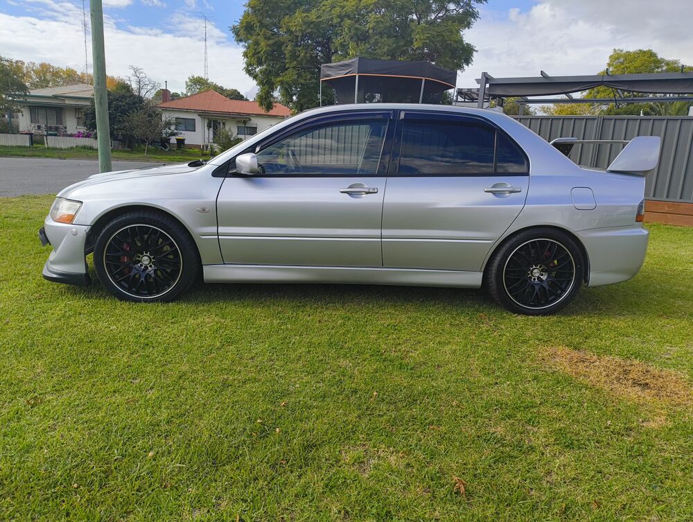 Driver side profile — full silhouette with GT wing, Lenso Type-M wheels