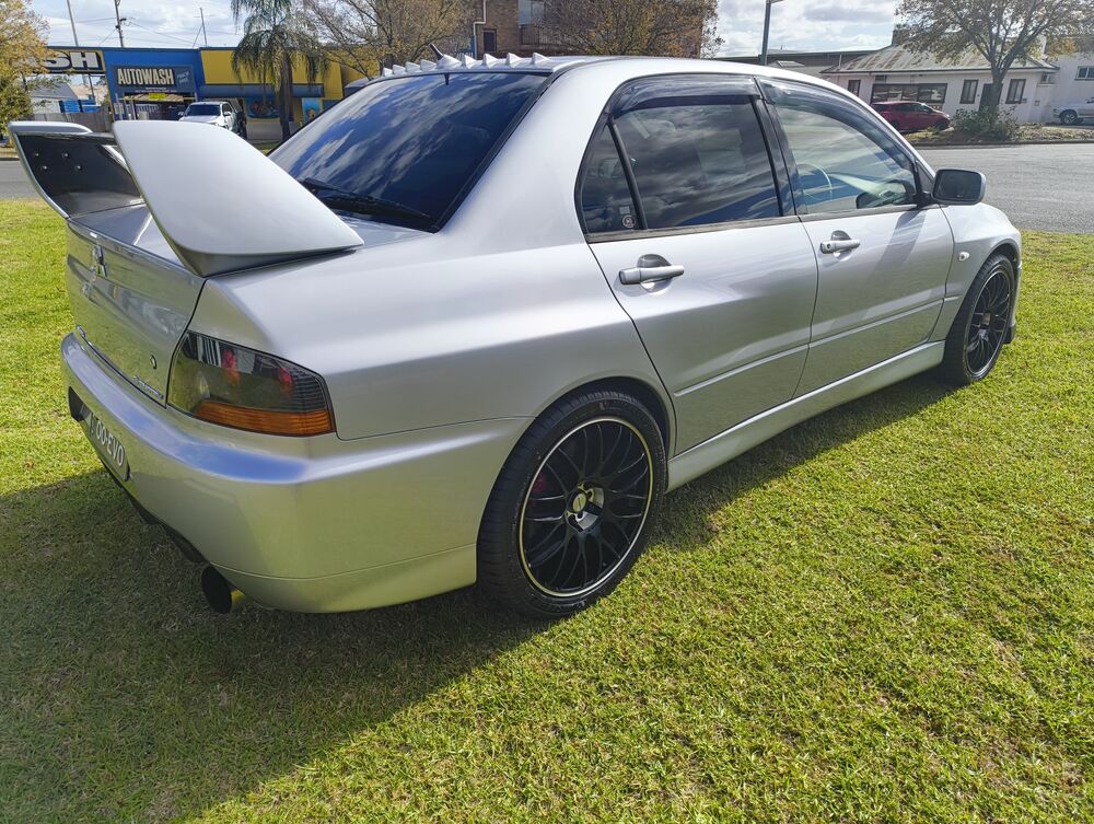 Rear three-quarter from the passenger side — GT wing, rear arches, wheels